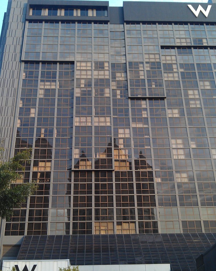 Reflective glass facade of The Starling Atlanta Midtown hotel tower