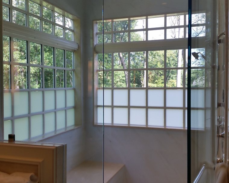 Frosted privacy film banding the lower panes of a residential sunroom